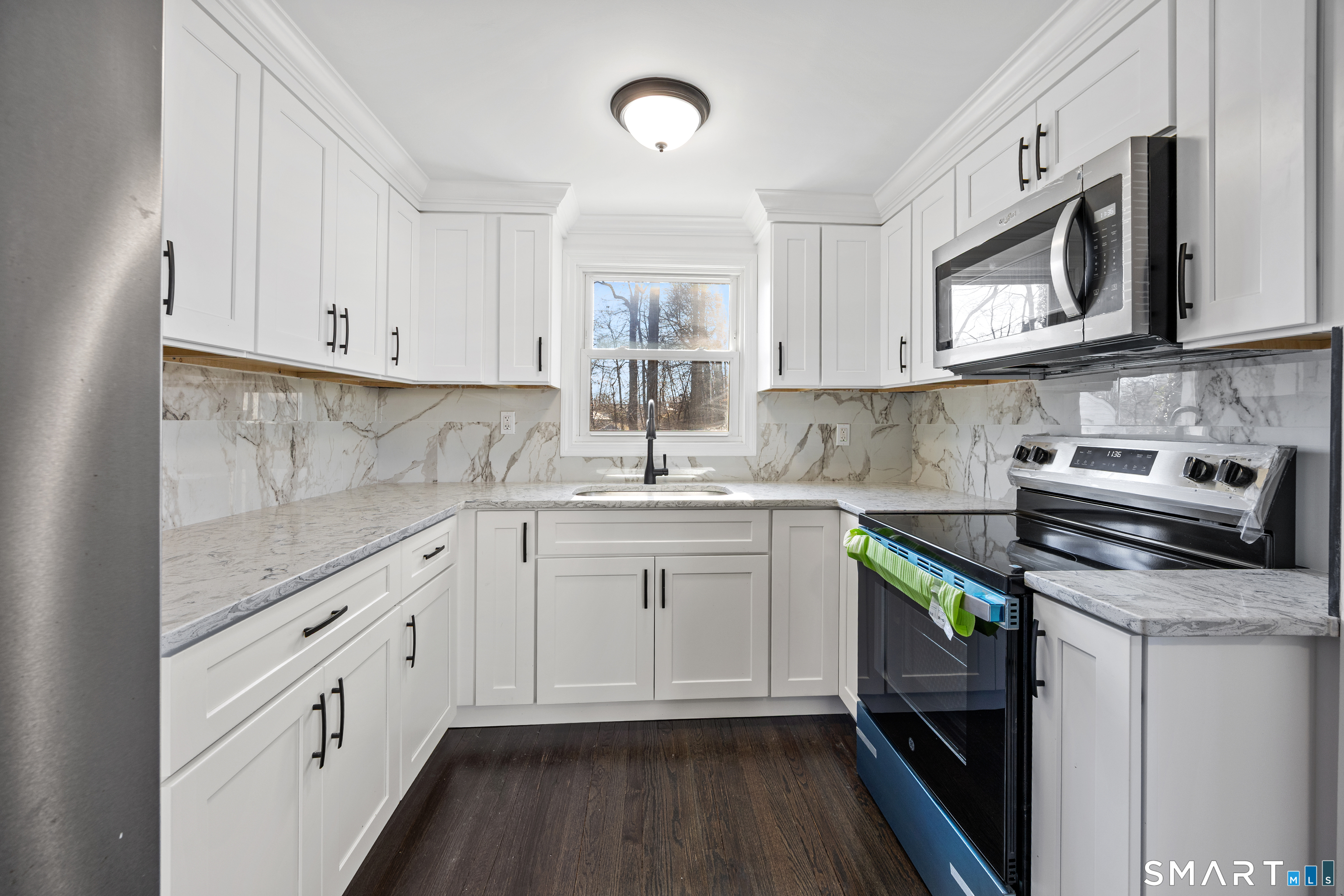 148 Burwell Road West Haven, CT 06516 - Photo 11 of 33 a kitchen with stainless steel appliances granite countertop a sink stove and cabinets