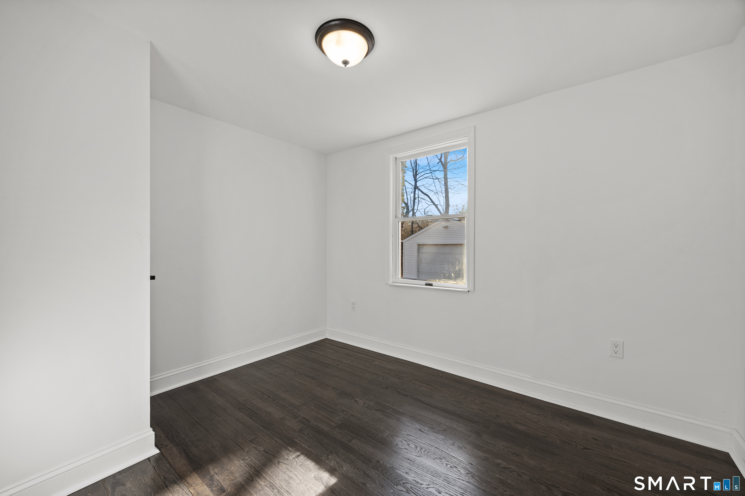 148 Burwell Road West Haven, CT 06516 - Photo 16 of 33 an empty room with wooden floor and windows
