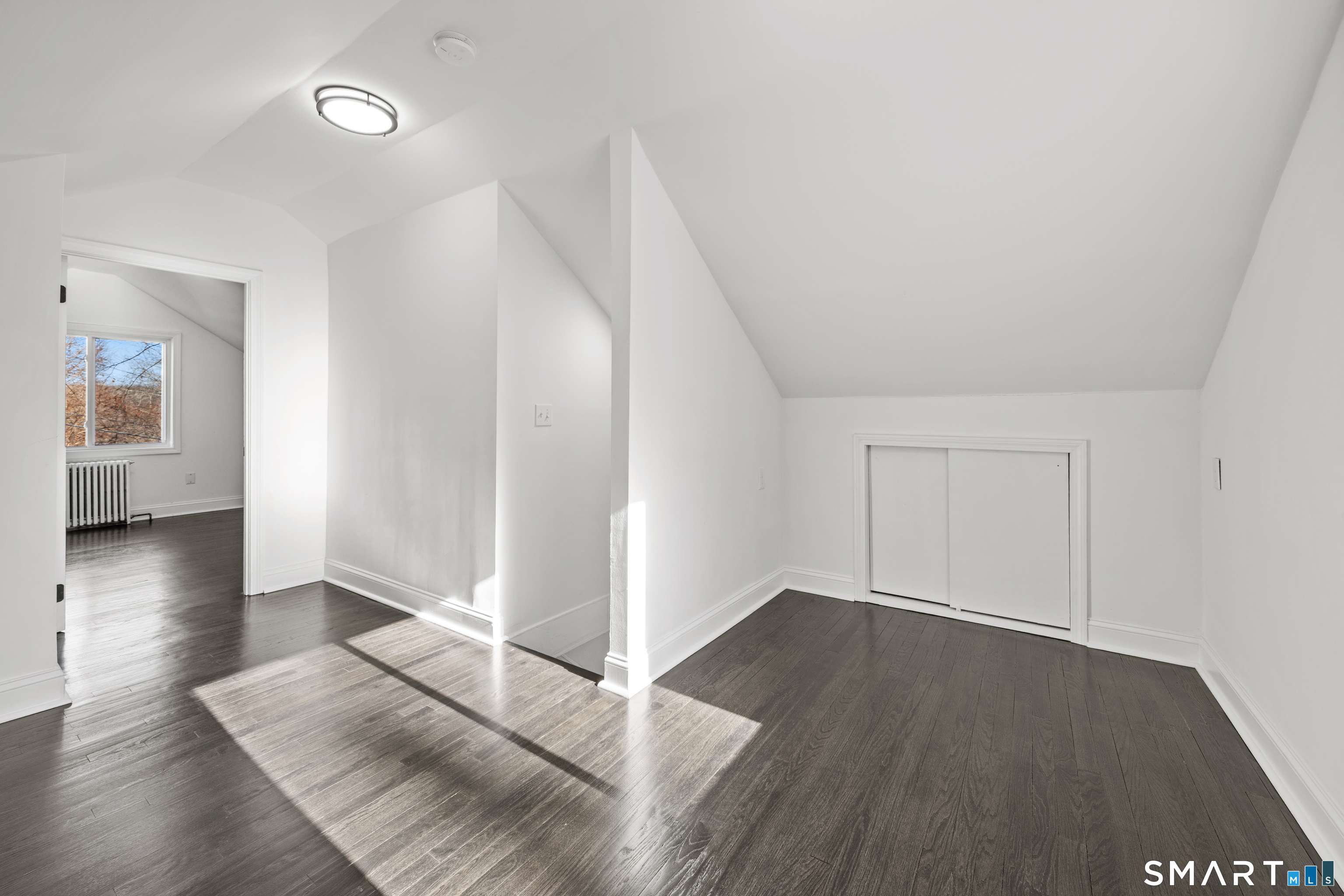 148 Burwell Road West Haven, CT 06516 - Photo 18 of 33 an empty room with wooden floor and windows