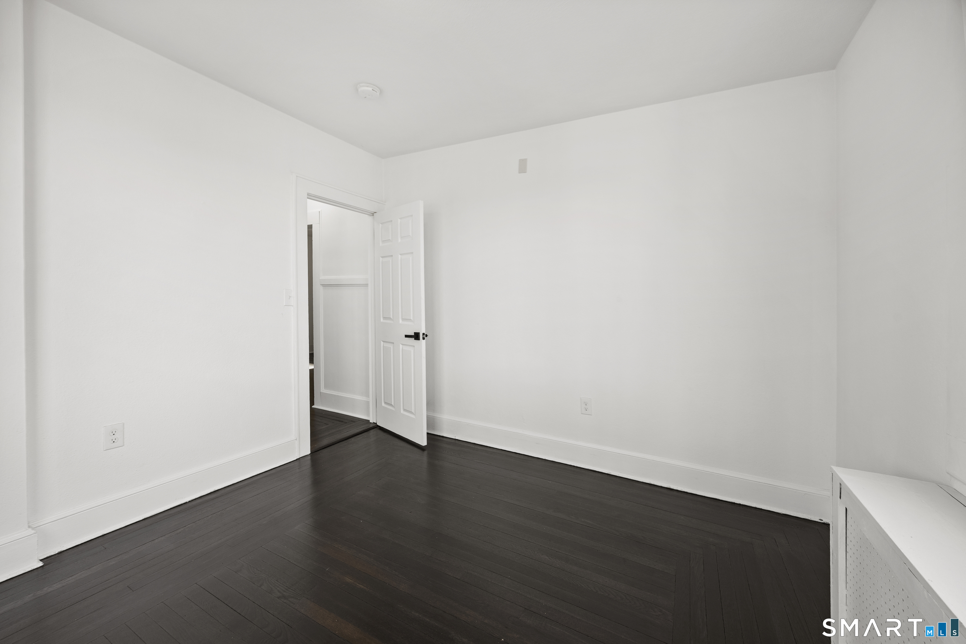 148 Burwell Road West Haven, CT 06516 - Photo 19 of 33 an empty room with wooden floor and white walls