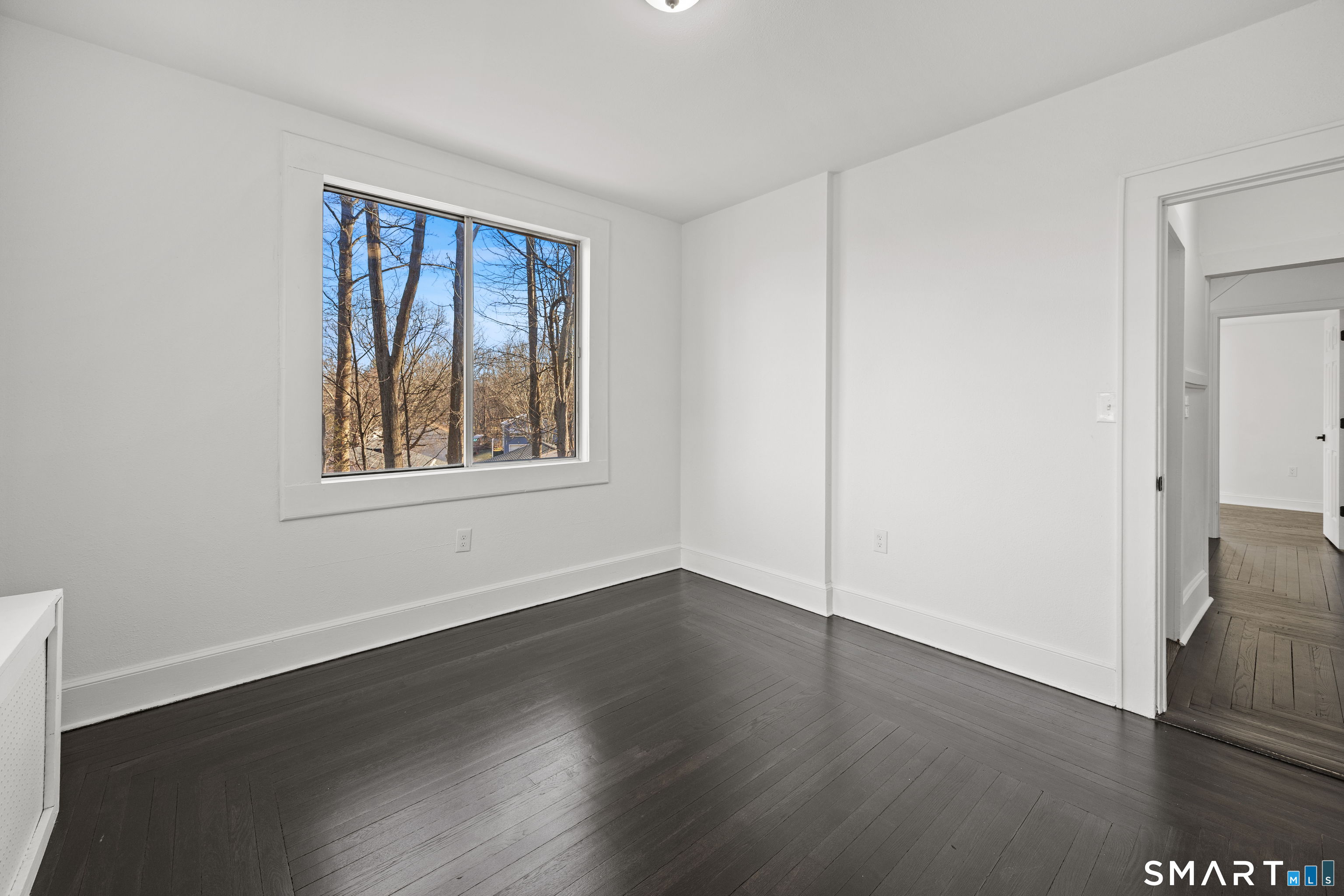 148 Burwell Road West Haven, CT 06516 - Photo 23 of 33 a view of an empty room with wooden floor and a window