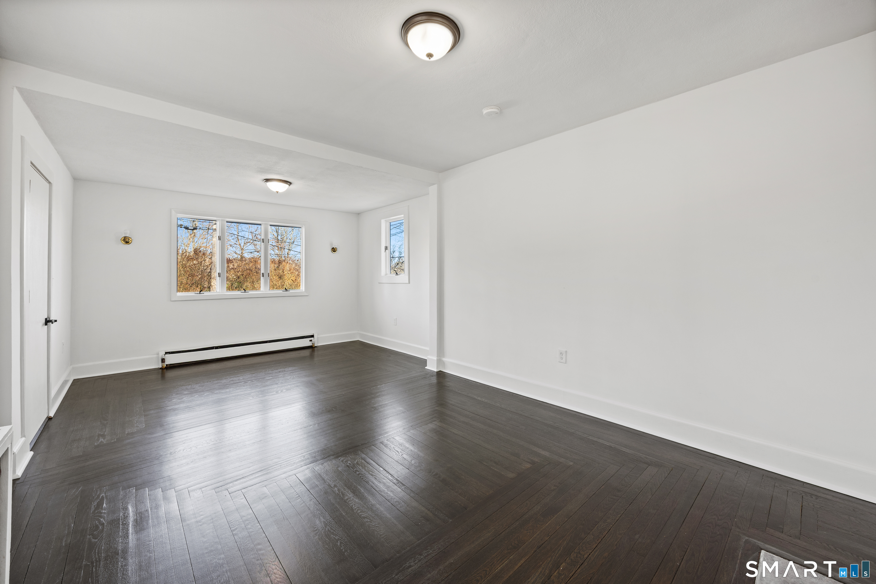 148 Burwell Road West Haven, CT 06516 - Photo 6 of 33 an empty room with wooden floor and windows