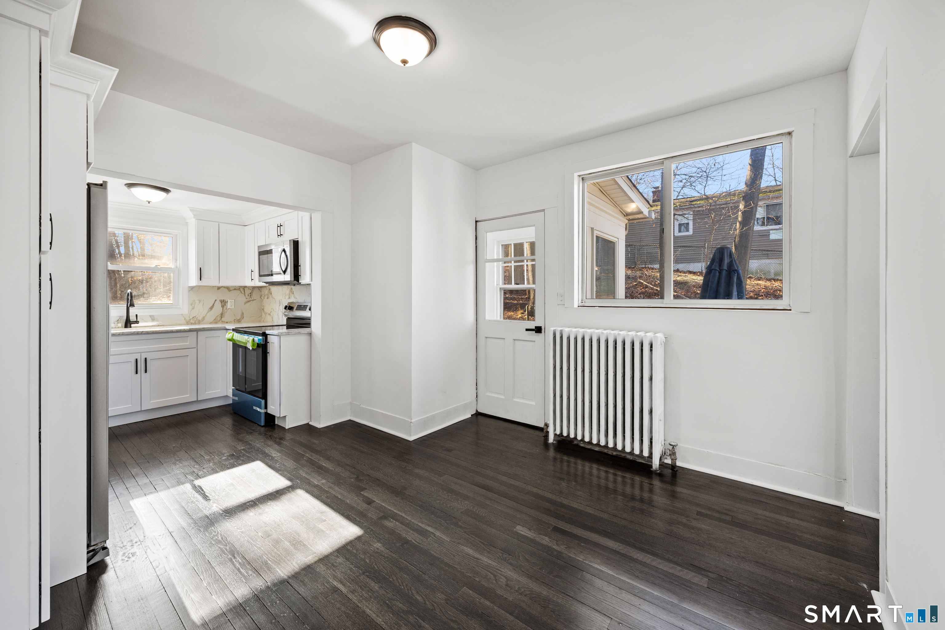 148 Burwell Road West Haven, CT 06516 - Photo 7 of 33 a view of a kitchen with wooden floor and a window