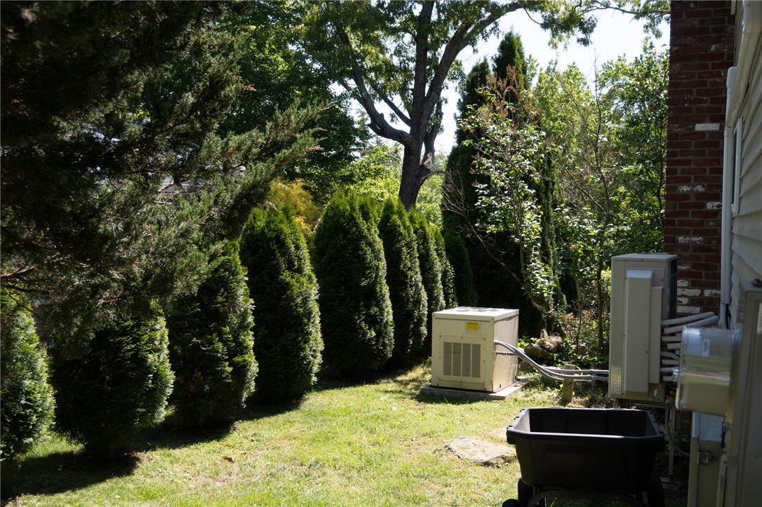 36 Pine Tree Road Coventry, RI 02816 - Photo 37 of 45 Generator hidden to the side, privacy hedges down the property side
