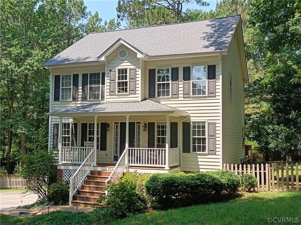 3206 Ludgate Road Chester, VA 23831 - Photo 1 of 45 a view of a white house with large windows and a yard with plants and a large tree