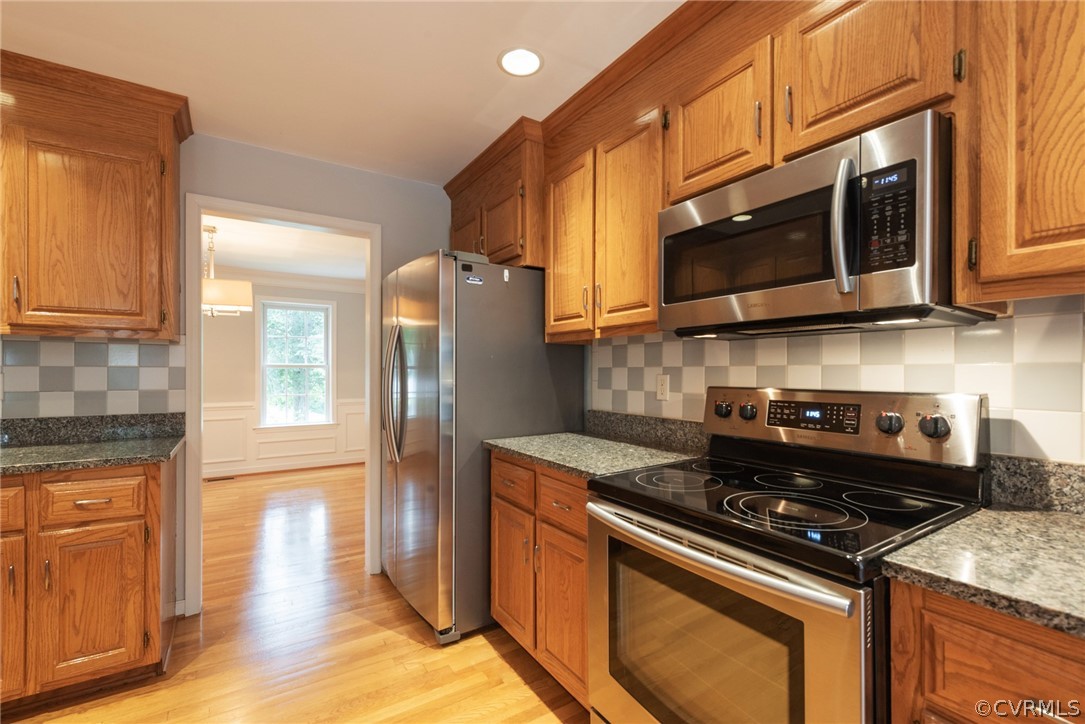 3206 Ludgate Road Chester, VA 23831 - Photo 24 of 45 a kitchen with stainless steel appliances granite countertop a stove a refrigerator and a microwave