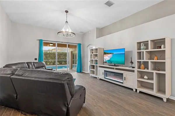 a living room with furniture and a floor to ceiling window