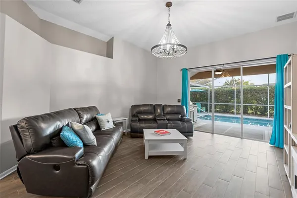a living room with furniture and kitchen view