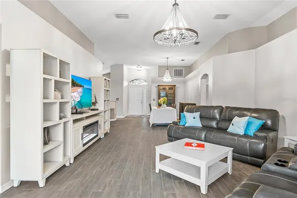 a living room with furniture and a flat screen tv