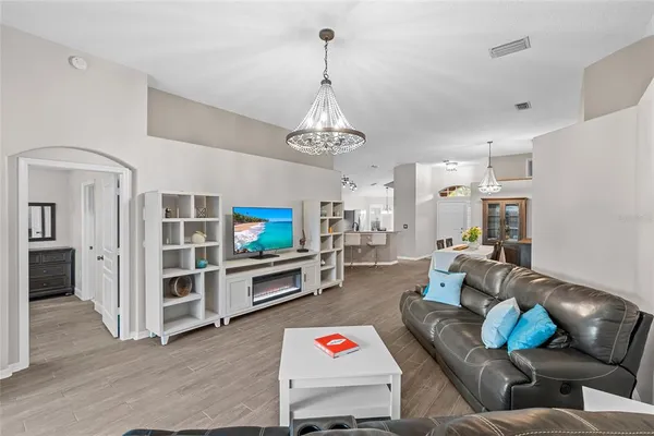 a bedroom with a large bed and a chandelier