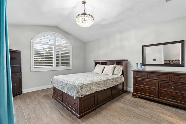 a bedroom with a bed and a large window
