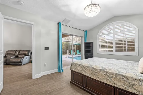 a spacious bathroom with a granite countertop sink a toilet a bathtub a mirror and vanity