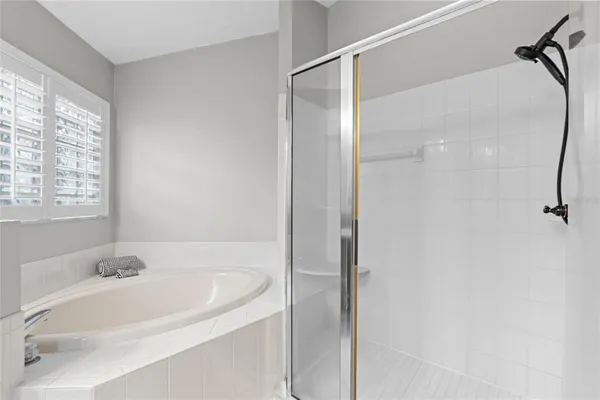 a bedroom with a bed and a lamp