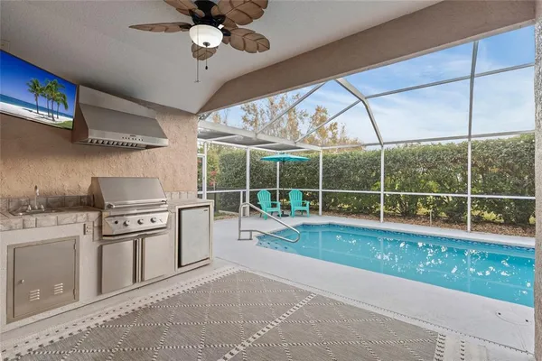 an aerial view of a house with a swimming pool yard and outdoor seating
