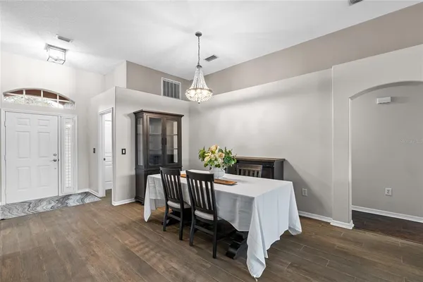a view of a dining room with furniture window and wooden floor