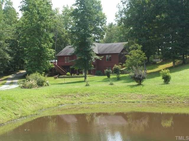 1055 Johnny Shaw Road Moncure, NC 27559 - Photo 1 of 12 Front view of home highlighting pond