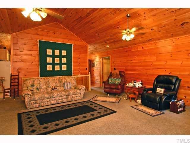 1055 Johnny Shaw Road Moncure, NC 27559 - Photo 6 of 12 Living area for family entertaining. Beautiful logs create a cozy feel.