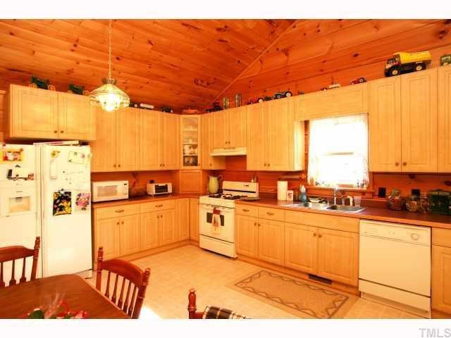1055 Johnny Shaw Road Moncure, NC 27559 - Photo 7 of 12 Eat-in kitchen with custom cabinets. Walk-in pantry off kitche area for all your storage needs.