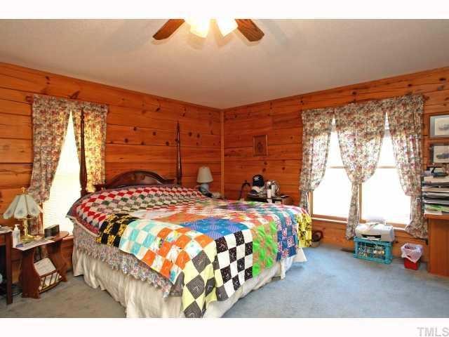 1055 Johnny Shaw Road Moncure, NC 27559 - Photo 8 of 12 Large master bedroom on main level with private bath.