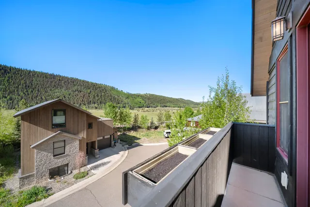 a view of balcony with furniture and city view