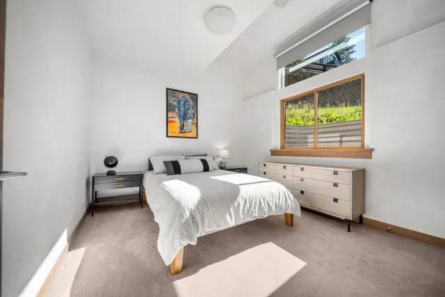 a bedroom with a bed and a couch