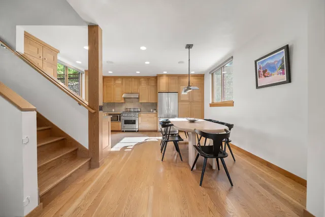 a view of a dining room with furniture a chandelier and wooden floor