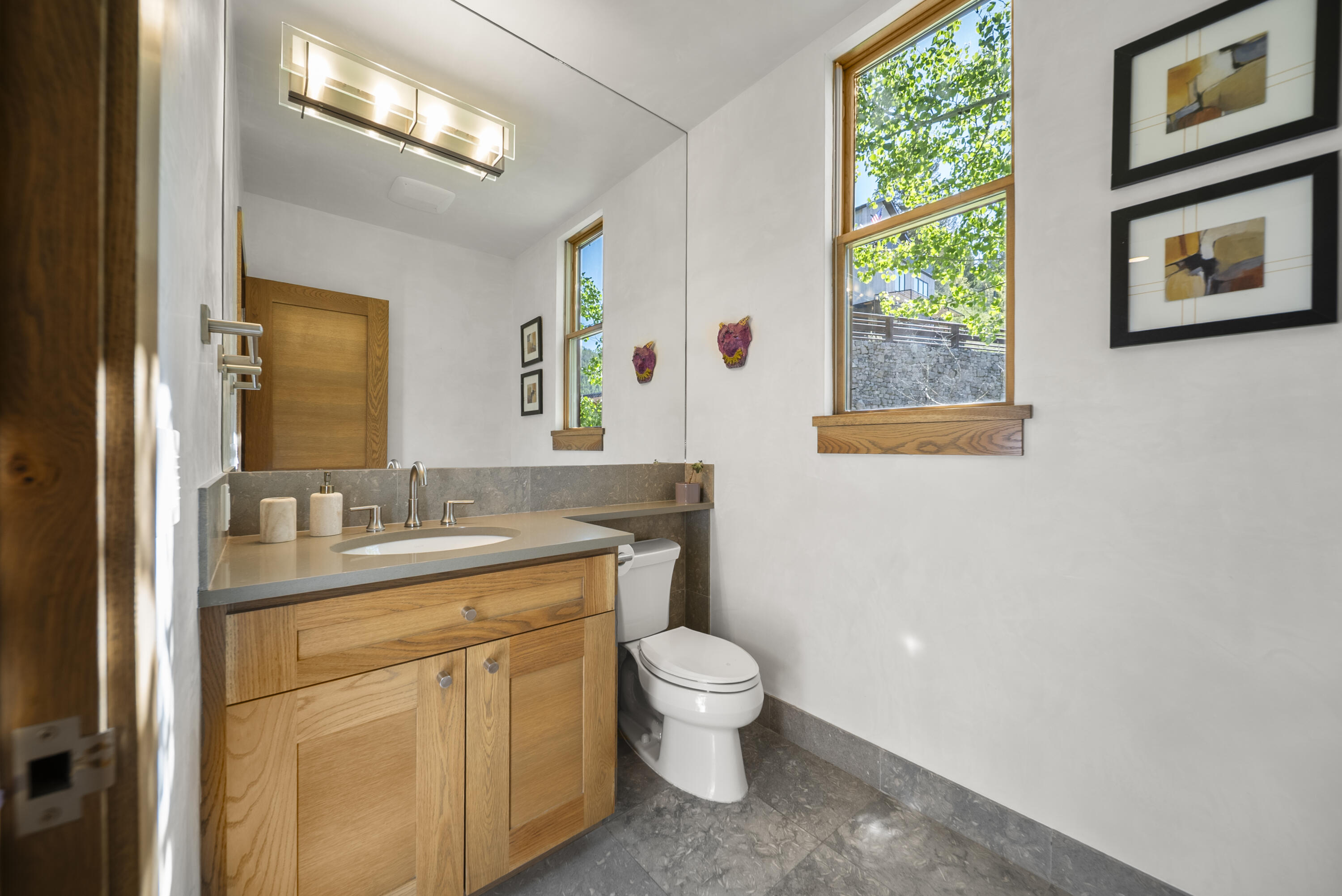 245 South Sunset Ridge Drive Telluride, CO 81435 - Photo 8 of 26 a bathroom with a granite countertop toilet a sink and a mirror