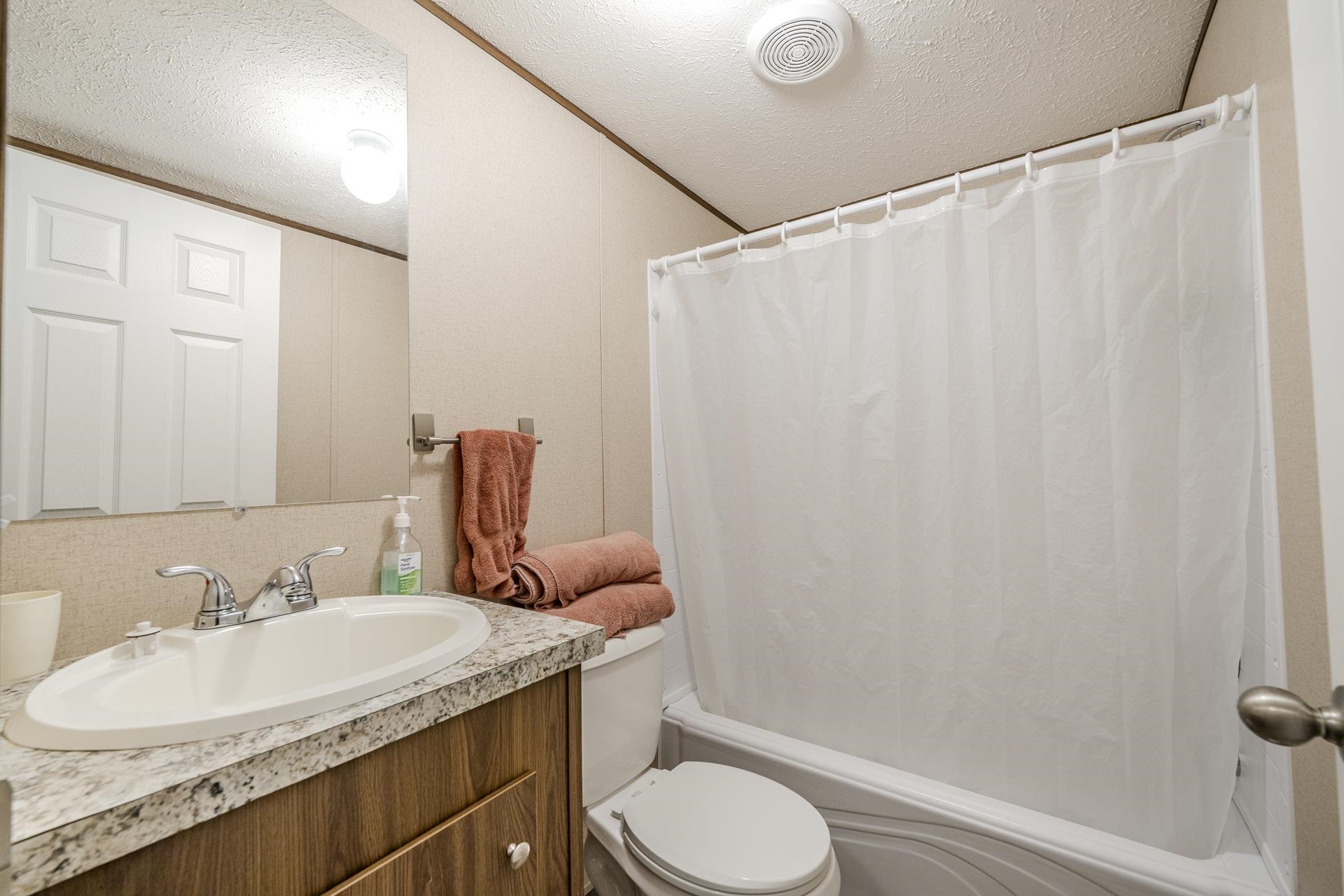 3275 Glendale Road Adamsville, TN 38310 - Photo 25 of 39 a bathroom with a granite countertop sink and a mirror