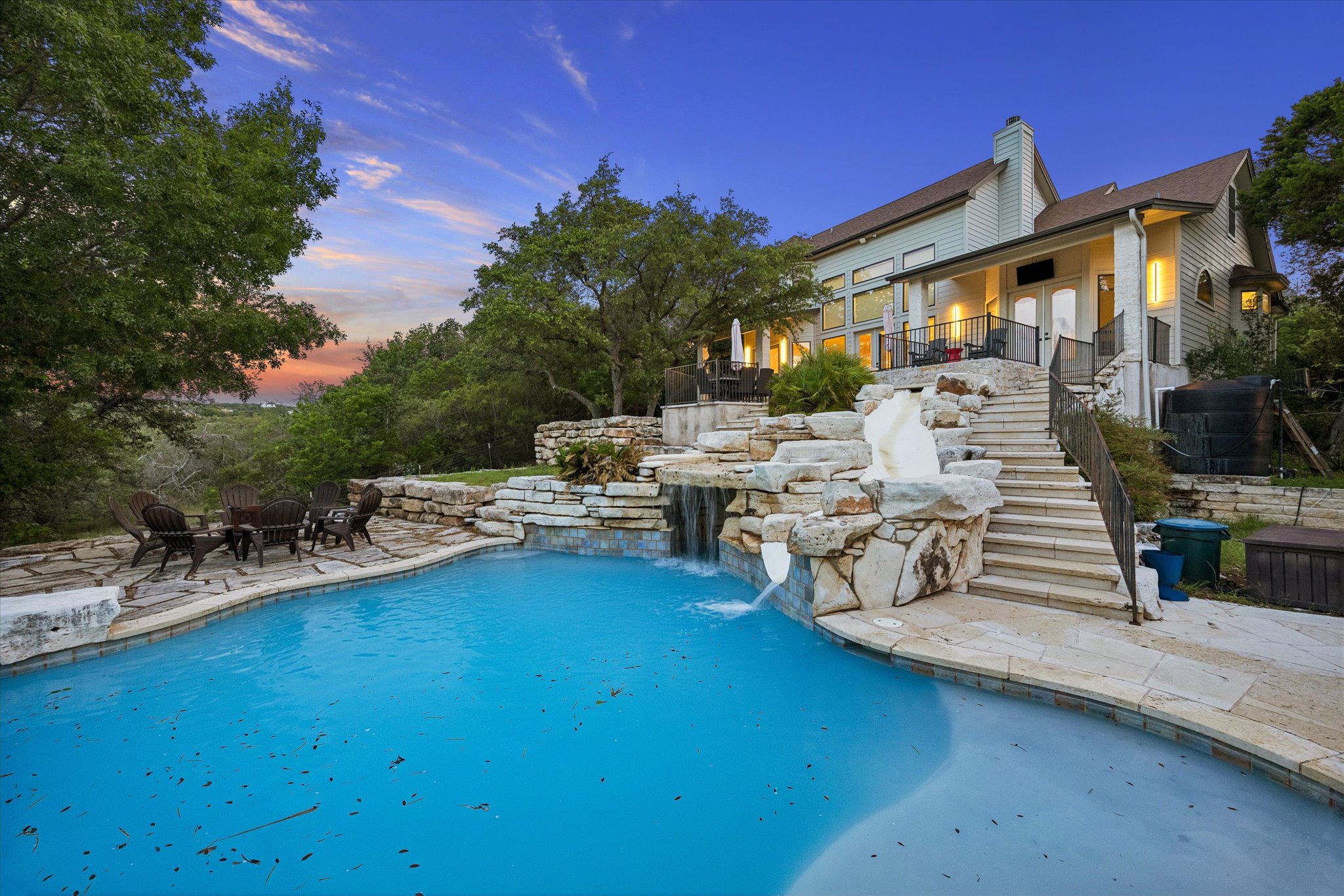 3719 Bee Creek Road Spicewood, TX 78669 - Photo 34 of 40 Discover a private outdoor oasis with a refreshing pool, cascading waterfall, and elevated deck for scenic views.