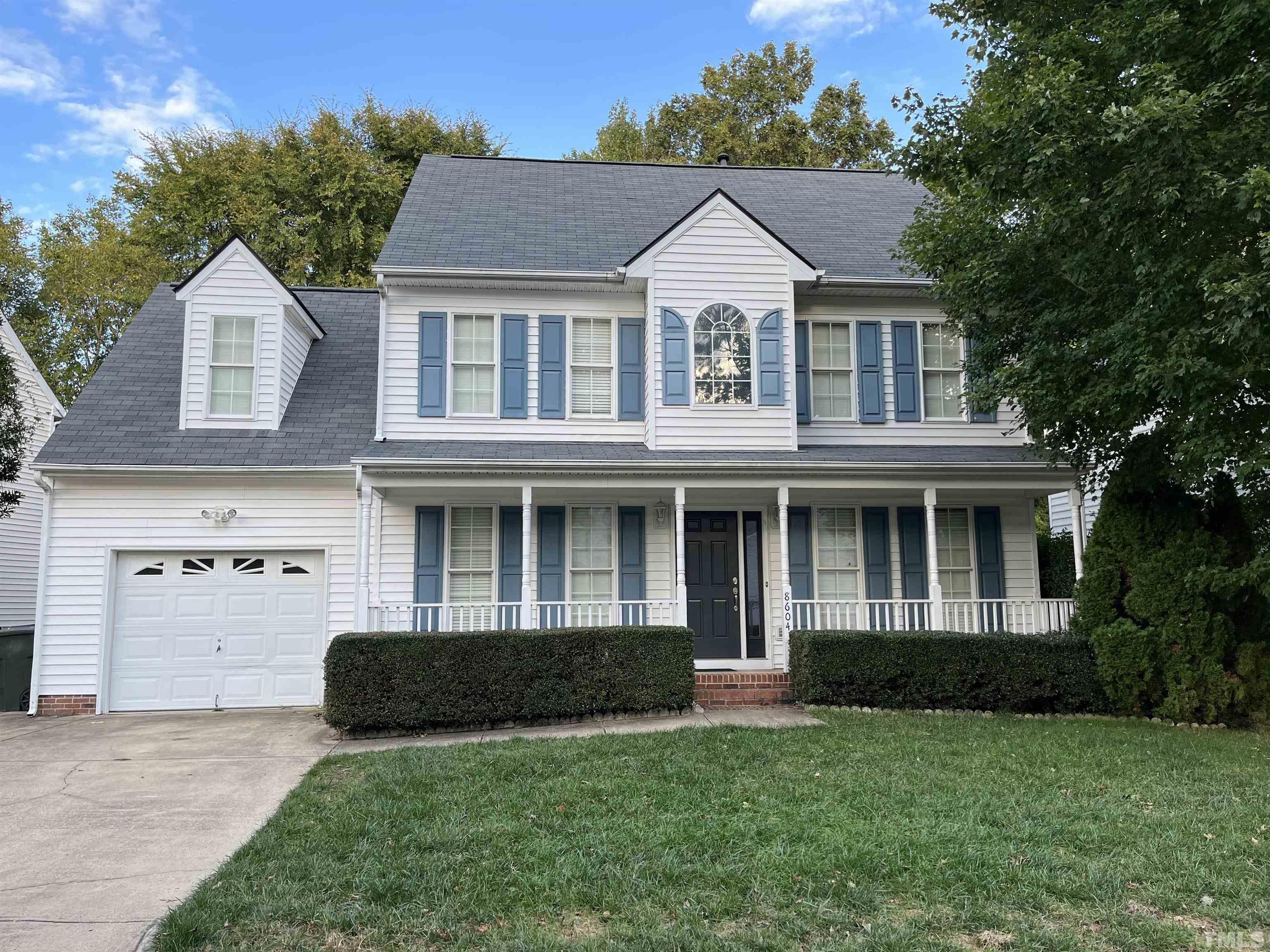 8604 Clivedon Drive Raleigh, NC 27615 - Photo 1 of 16 a front view of a house with a yard and garage