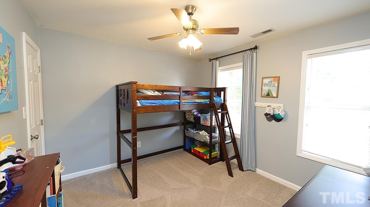 8604 Clivedon Drive Raleigh, NC 27615 - Photo 13 of 16 a view of a livingroom with furniture and a ceiling fan
