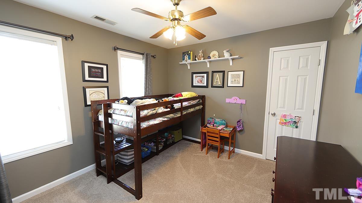 8604 Clivedon Drive Raleigh, NC 27615 - Photo 14 of 16 a room with furniture and a window