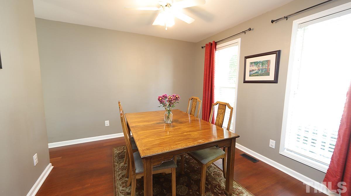 8604 Clivedon Drive Raleigh, NC 27615 - Photo 5 of 16 a view of a dining room with furniture and wooden floor