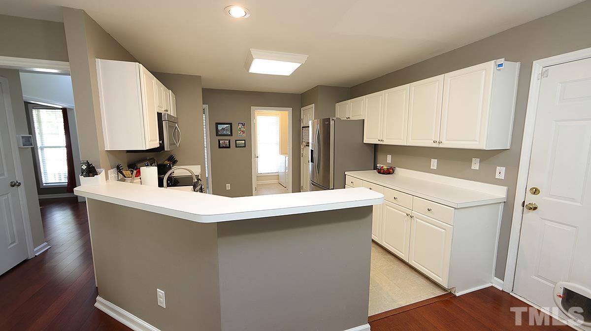 8604 Clivedon Drive Raleigh, NC 27615 - Photo 6 of 16 a kitchen with a sink stove and cabinets
