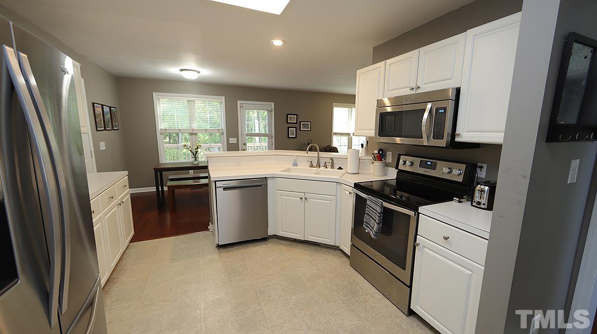 8604 Clivedon Drive Raleigh, NC 27615 - Photo 7 of 16 a kitchen with a sink stove and refrigerator