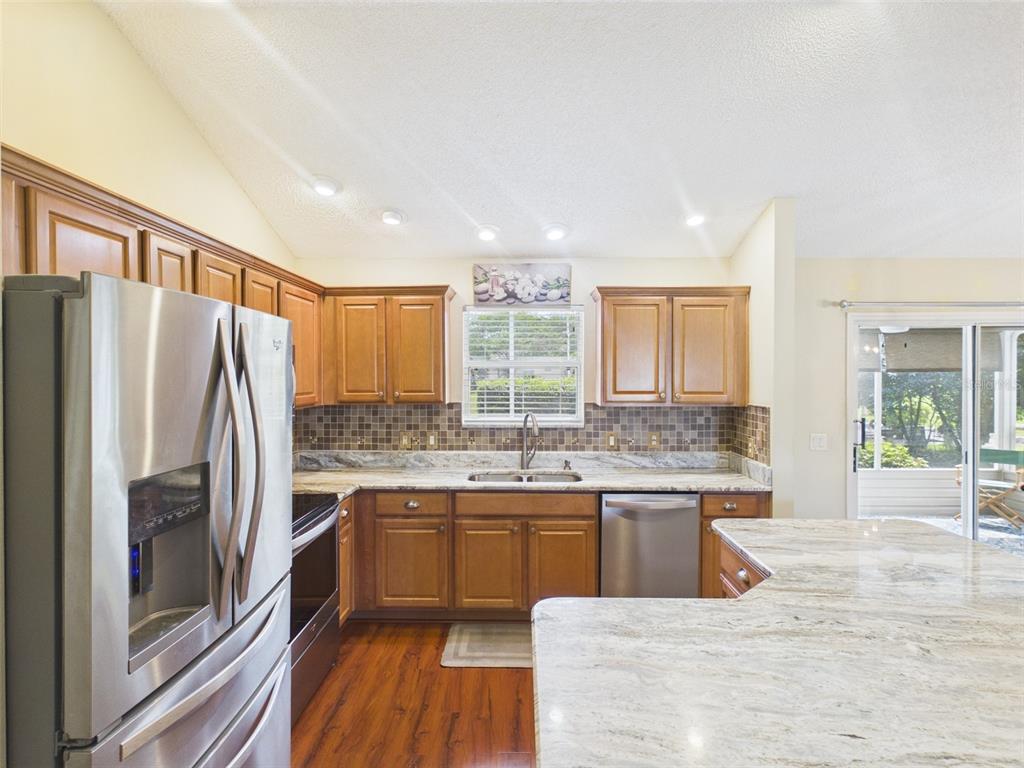 2297 Welcome Way The Villages, FL 32162 - Photo 16 of 36 a kitchen with a sink refrigerator and cabinets