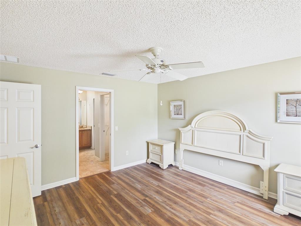 2297 Welcome Way The Villages, FL 32162 - Photo 21 of 36 a bedroom with a bed and a dresser