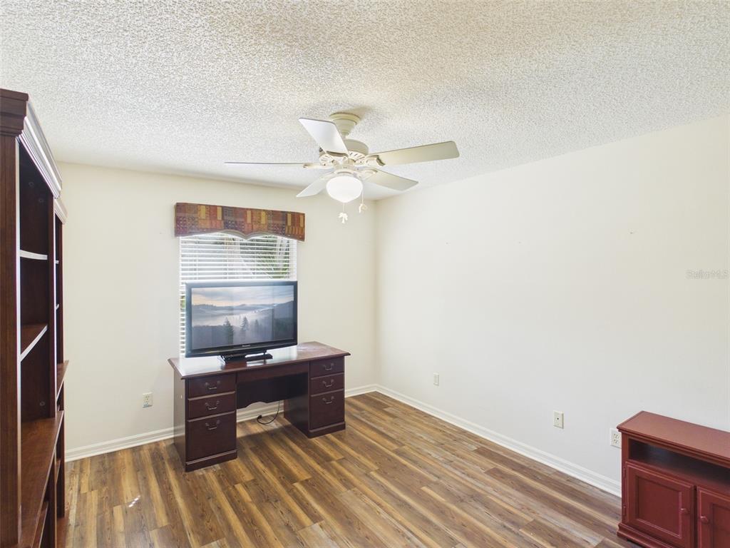 2297 Welcome Way The Villages, FL 32162 - Photo 27 of 36 a living room with furniture and a table
