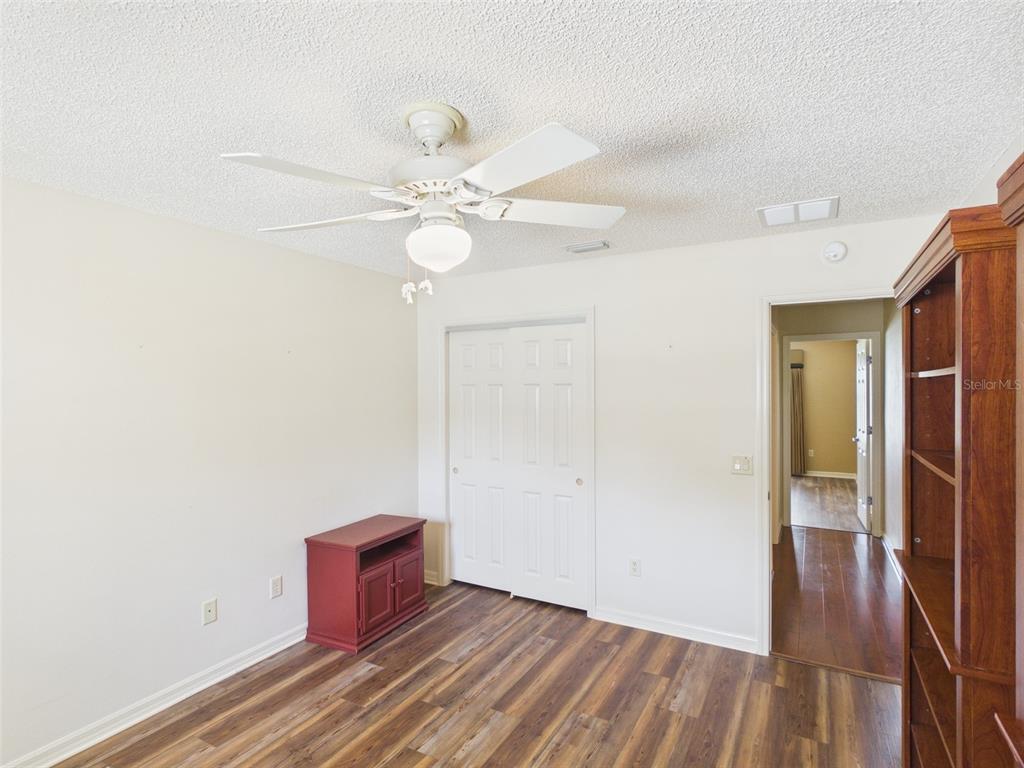 2297 Welcome Way The Villages, FL 32162 - Photo 28 of 36 wooden floor in an empty room