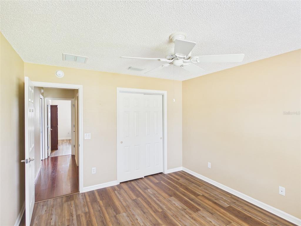 2297 Welcome Way The Villages, FL 32162 - Photo 29 of 36 a view of a room with wooden floor and closet area
