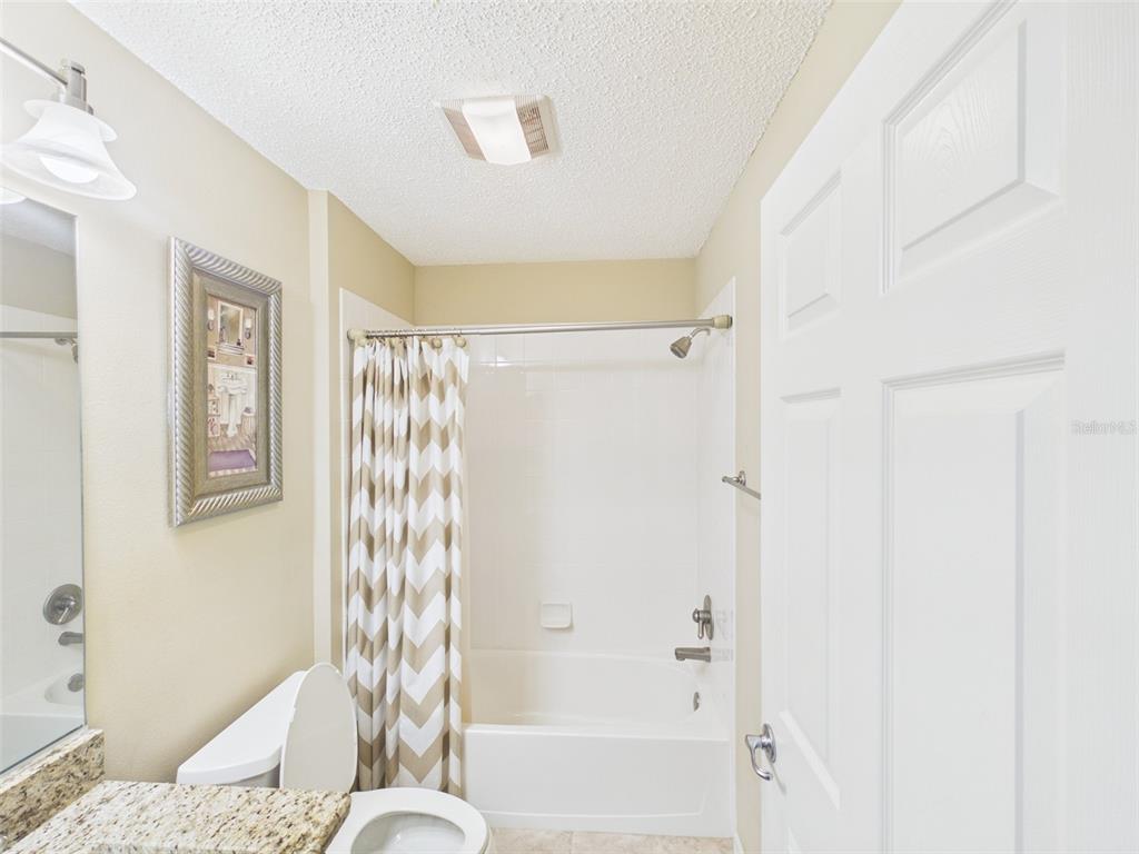 2297 Welcome Way The Villages, FL 32162 - Photo 32 of 36 a bathroom with a bathtub and shower