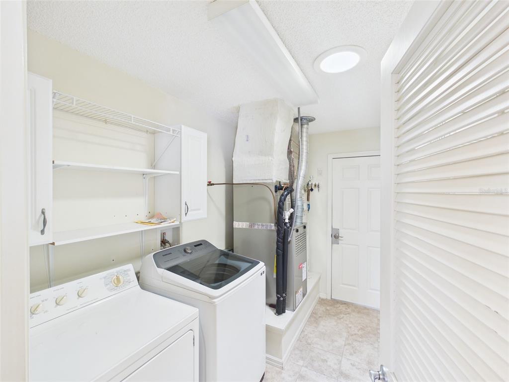 2297 Welcome Way The Villages, FL 32162 - Photo 33 of 36 a kitchen with a refrigerator and a sink