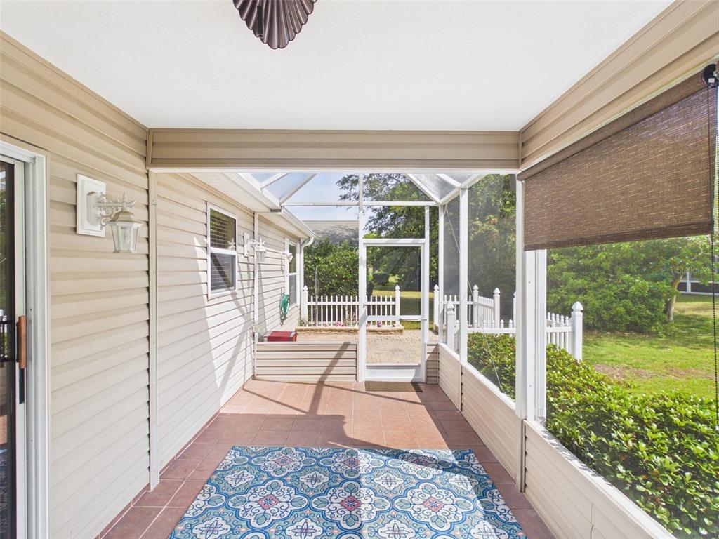 2297 Welcome Way The Villages, FL 32162 - Photo 9 of 36 a view of a porch with wooden floor and outdoor space