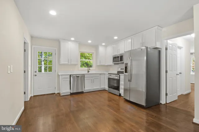 a kitchen with stainless steel appliances a refrigerator sink and stove