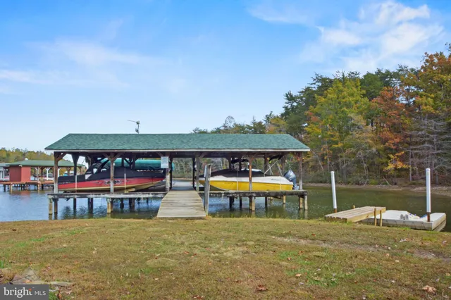 a view of a swimming pool with a patio and a yard