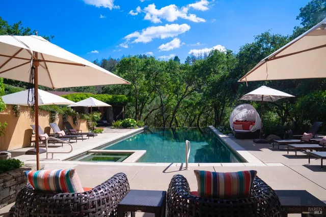 a view of a house with a yard and sitting area