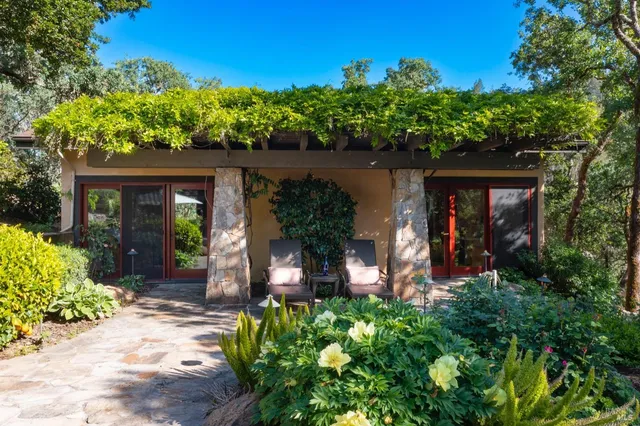 a view of a house with a tub and potted plants
