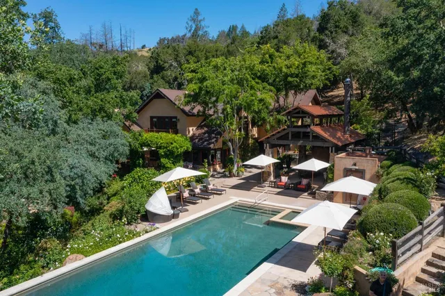 an aerial view of a house with garden space and sitting area