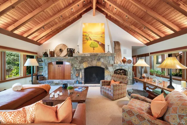 a view of a dining room and livingroom with furniture wooden floor a chandelier