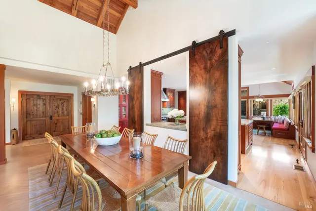 a view of a dining room with furniture large windows and wooden floor
